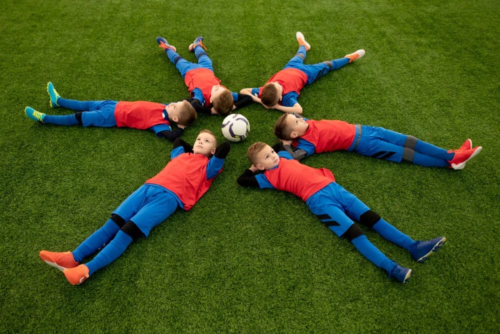 Young football player training with a football