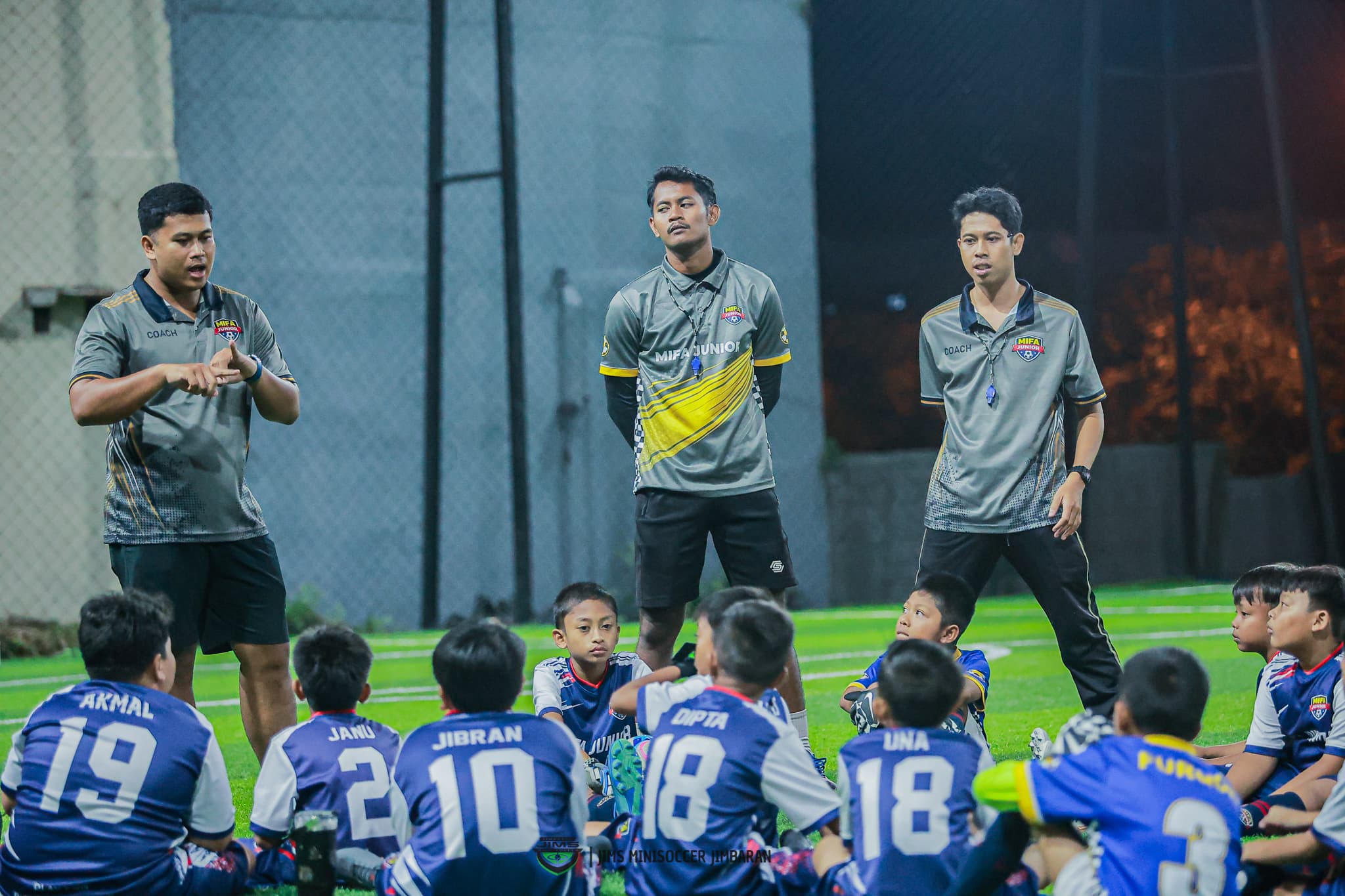 Young football player training with a football